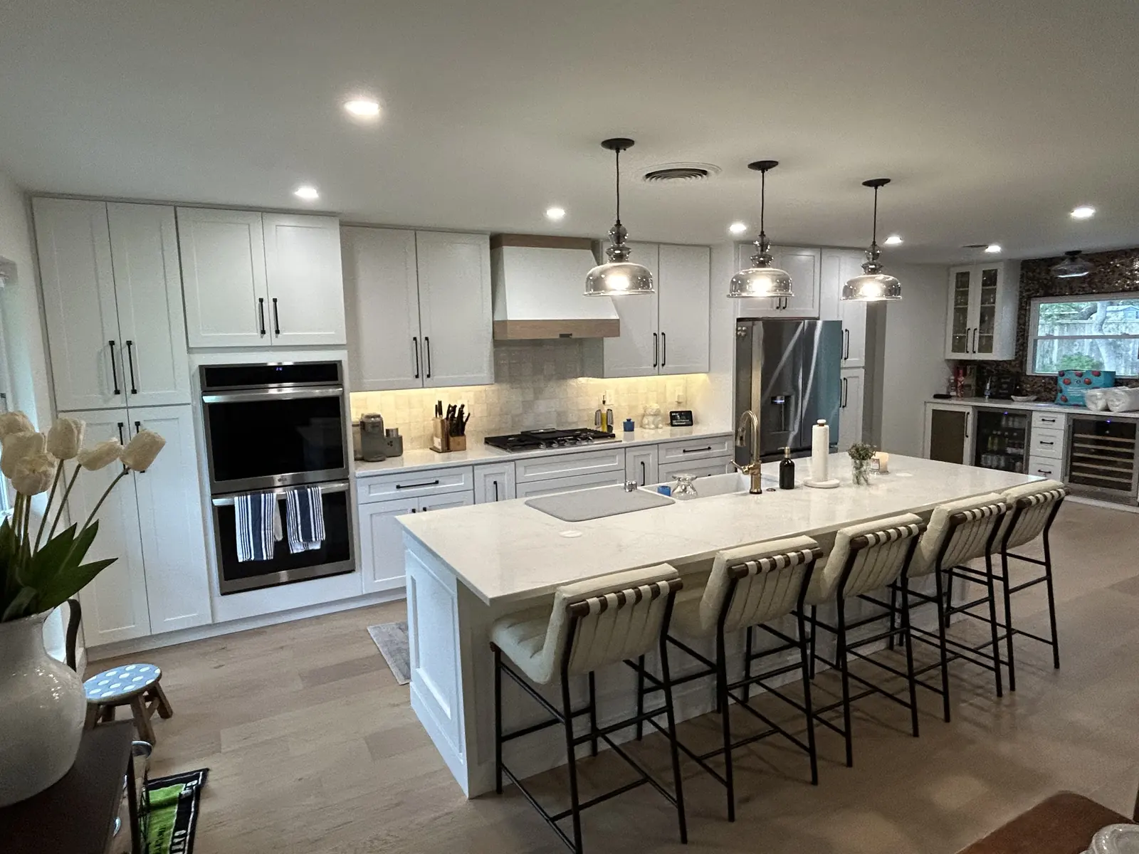 Hollywood Park kitchen with a wood wrapped range hood after a wall was removed